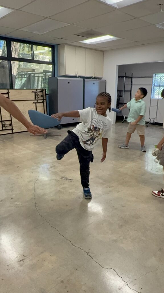 Young boys practicing karate in a school classroom.