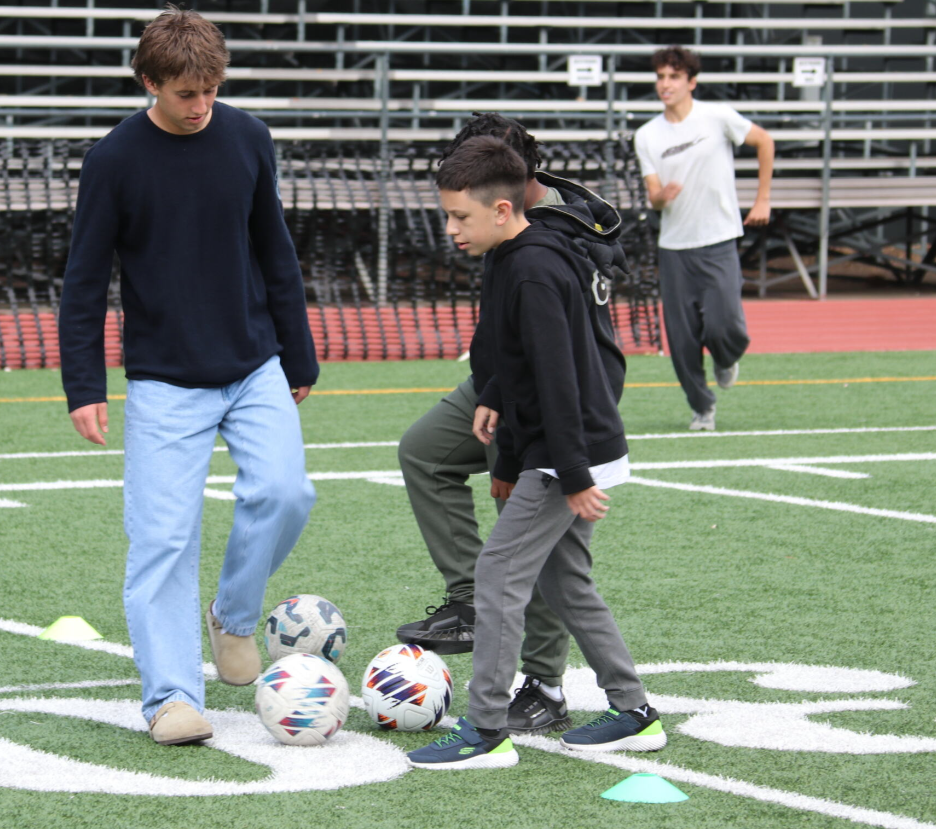 Young boys playing soccer on school playground