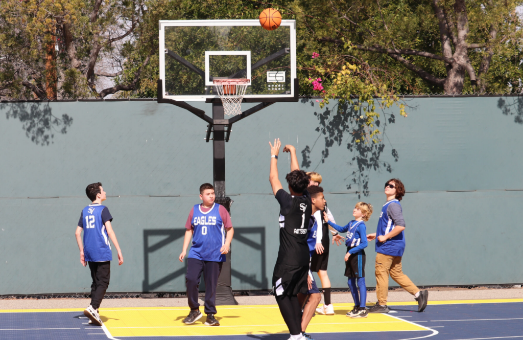 Young boys playing basketball on school playground