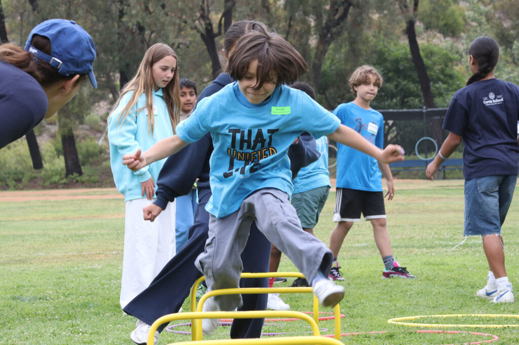 Boy running an obstacle course. Students from Curtis School and Help Group Bridgeport School gathered for their second annual Unified Field Day