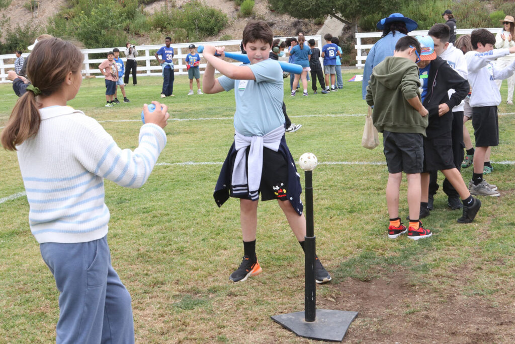 Young boy getting ready to swing a bat to hit a ball - Students from Curtis School and Help Group Bridgeport School gathered for their second annual Unified Field Day